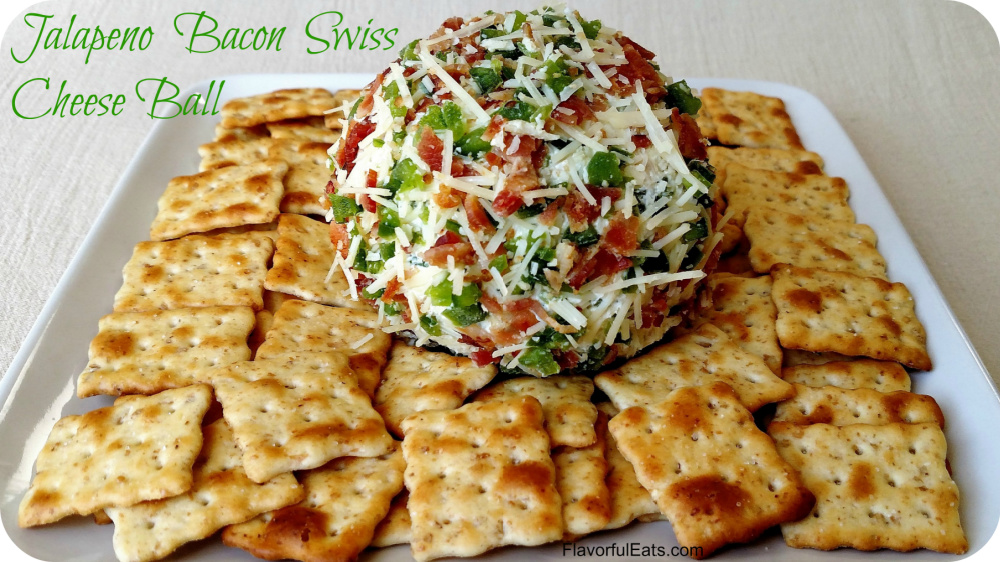 Jalapeno Bacon Swiss Cheese Ball sitting on a white plate with crackers on it.