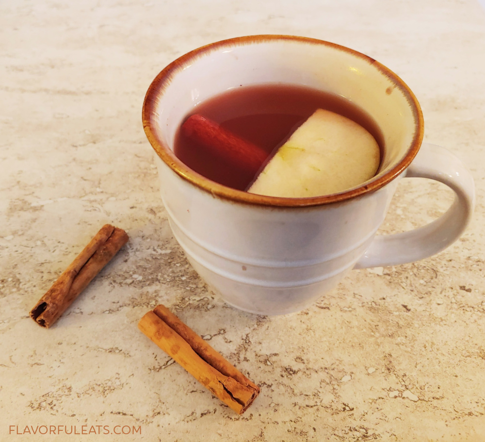 A mug of Spiced Apple Cranberry Warm Rum Punch
