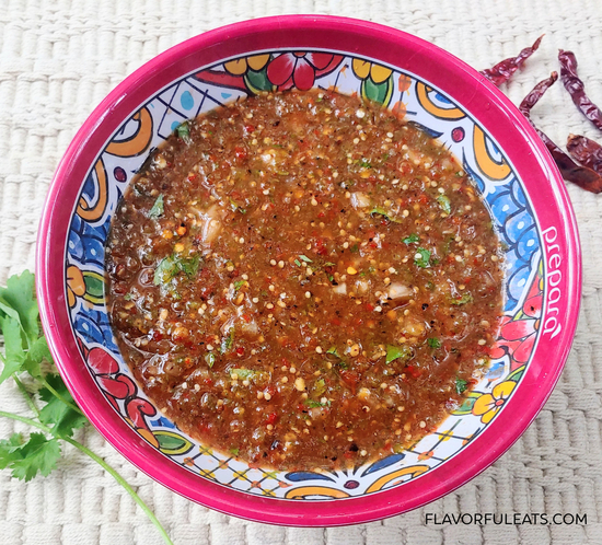 Colorful bowl filled with Chile de Arbol Tomatillo Salsa
