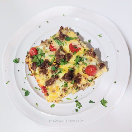 A square slice of Southwest Breakfast Casserole on a round plate.